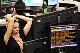 Traders work at the stock exchange in Frankfurt