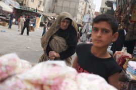a boy sells candy in a market in damascus'' seyda zaynab neighbourhood