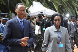 Rwandan president Paul Kagame (L) walks with aide Rose Kabuye