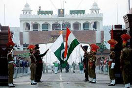 Pakistani Rangers (In Black) and Indian Border Security Force personnel perform the daily retreat ceremony on the India-Pakistan Border at Wagah on December 2,2008. Pakistan offered to work hand-in-hand with India to track down those responsible for the Mumbai attacks but declined to respond immediately to a demand that it hand over 20 terrorist suspects. AFP PHOTO/Narinder NANU