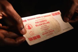 A shopper displays a five hundred million dollar Zimbabwean bank note June 29, 2008 in Bulawayo, Zimbabwe[File: John Moore/Getty Images)