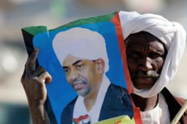 Man holds poster of OMar al-Bashi Sudan''s president