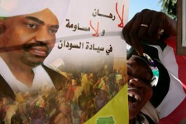 Al-Bashir supporter holds poster of Sudan president