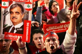 Lebanese protester shouts slogans as another holds a picture of slain former Prime Minister Rafik Hariri as they take part in an anti-Syria demonstration in Martyr''s Square in Beirut, Lebanon, photo