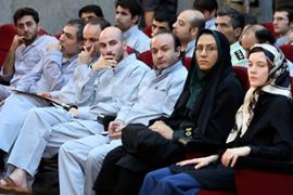 French language teaching assistant Clotilde Reiss sits next to Iranian policewoman in a court room in Tehran