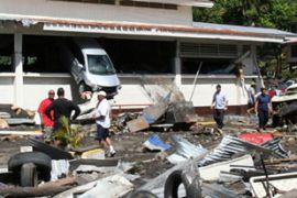 Car buried in building after tsunami in American Samoa