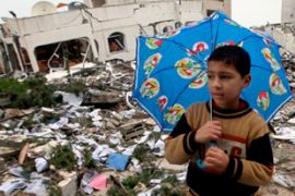 Boy stands in rubble of Gaza building destroyed by Israel