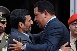 Iranian President Mahmoud Ahmadinejad (L) embraces his Venezuelan counterpart, Hugo Chavez, upon his arrival at Miraflores presidential palace in Caracas