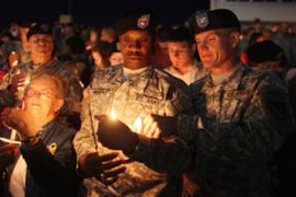 Soldiers hold candles at memorial service for troops shot in Fort Hood