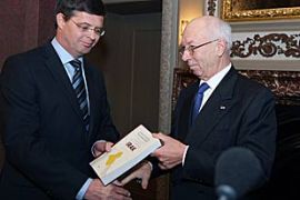 Willibrord Davids, a former president of the Dutch Supreme Court, presents the outcome of a Dutch inquiry into the legality of the 2003 war in Iraq to Dutch Prime Minister Jan Peter Balkenende in The Hague