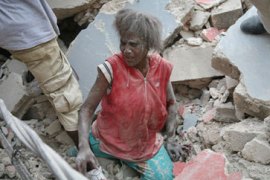 Woman climbs out of rubble of Haiti quake