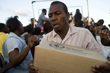 haiti and cuba, man with box of aid