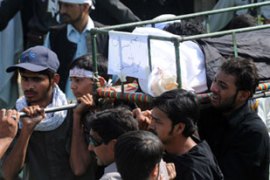 Mourners carry victim of Karachi bombings