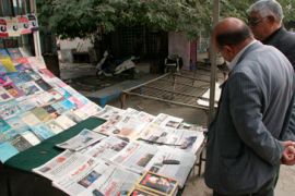 Iraqis reading the headlines of newspaper