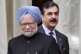 India''s PM Singh shakes and his Pakistani counterpart Gilani walk in Thimphu
