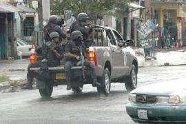 Police patrol sections of downtown Kingston, Jamaica...