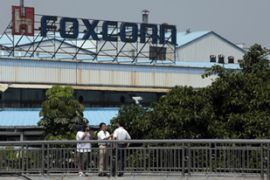 Foxconn employees speak to the media outside one of its factories in Shenzen, China