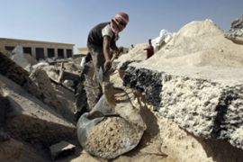 A Palestinian labourer collects gravel at abandoned airport in Rafah