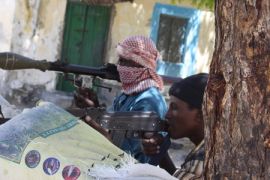 Somalia militant fighters aim guns