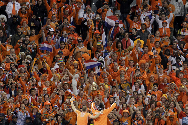 Netherlands'' Arjen Robben and Eljero Elia wave to fans after the team''s victory over Uruguay