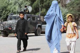 A burqa clad Afghan woman with children