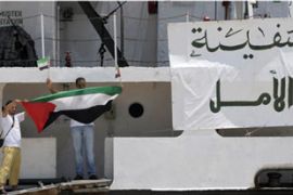 Libyan activists hold the Palestine flag aboard Libyan-chartered ship Amalthea