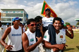 Teammates carry Sri Lanka''s Muttiah Muralitharan after winning first test cricket match against India