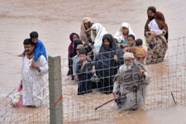 People wade through floods