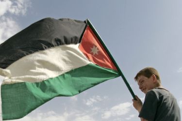 Jordanian national flag waved by young boy