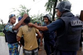 Police arrest a garment worker during a clash at Ashulia near Dhaka