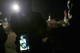 Relatives show video of trapped miners in Chile