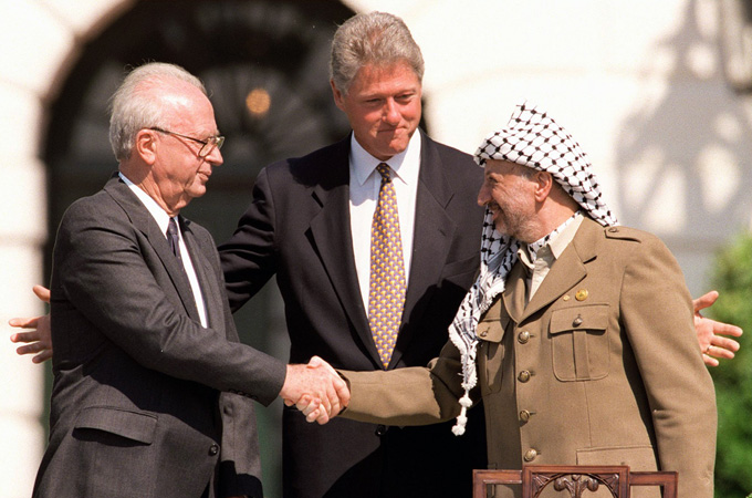 Bill Clinton, Yitzhak Rabin and Yasser Arafat shake hands at the White House in 1993.