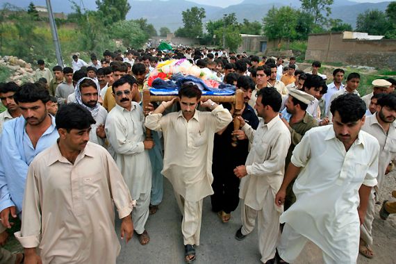 Men carry coffins of victims, who were killed in a car bomb attack in Kohat,Pakistan