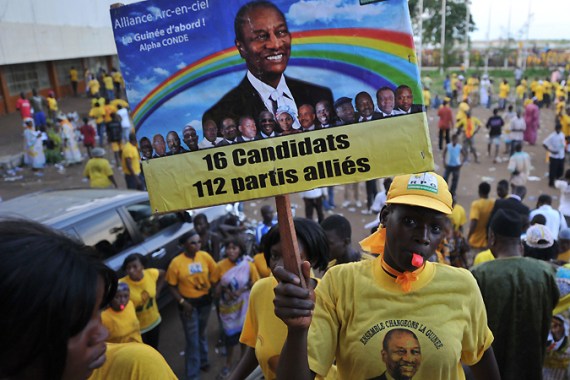 A supporter of Alpha Conde (unseen), Guinean presidential candidate for the Rally of the Guinean People party (GRP)