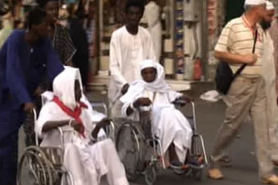 Workers pushing wheel chairs of disabled in Mecca, Saudi Arabia