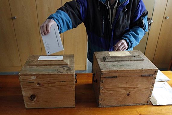 A man casts his ballots in Bauen, Switzerland, 28 November 2010. Reports state that Switzerland is voting on two referendums the referendum of Switzerlands right wing party (SVP) about the deportation of convicted delinquents