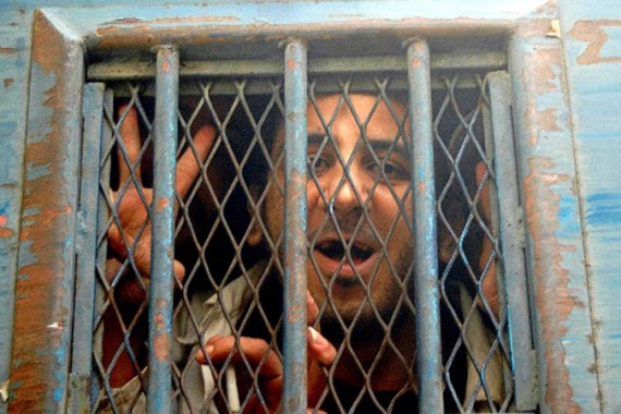 Jailed Egyptian blogger Kareem Amer shown behind bars
