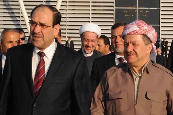Iraqi Prime Minister Nuri al-Maliki (L) walks alongside Kurdish regional president Massud Barzani