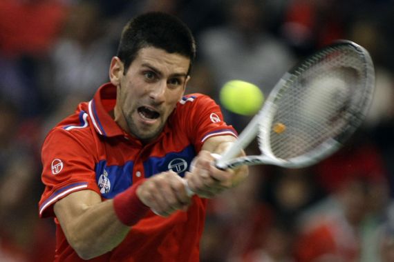 Serbia''s Djokovic returns the ball to France''s Simon