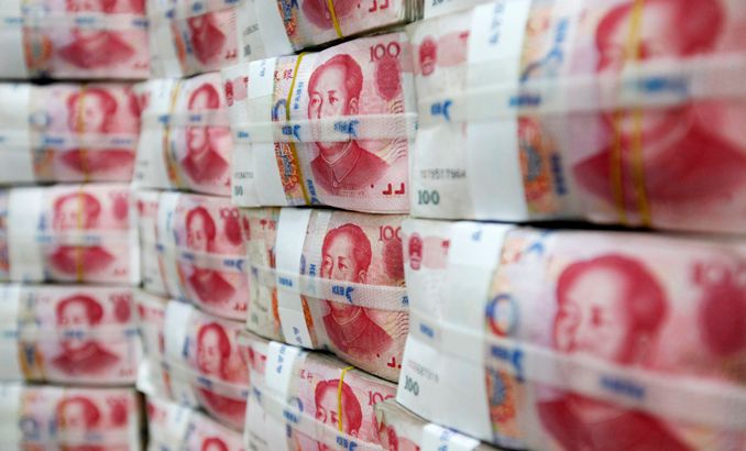 Inside Story - File photograph of Chinese yuan notes piled up after counting at a bank during a photo opportunity in Seoul