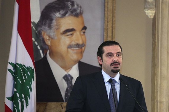 Saad Hariri standing in front of poster of his father, late Rafik Hariri