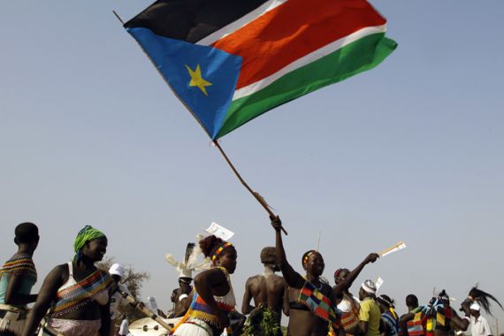 Sudanese man waves flag at Juba rally