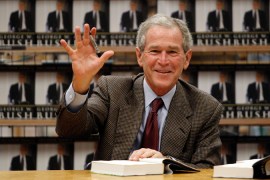 George W Bush waves at a book signing