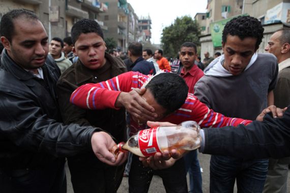 Protesters use Coca-Cola to wash tear-gas from their eyes and face.