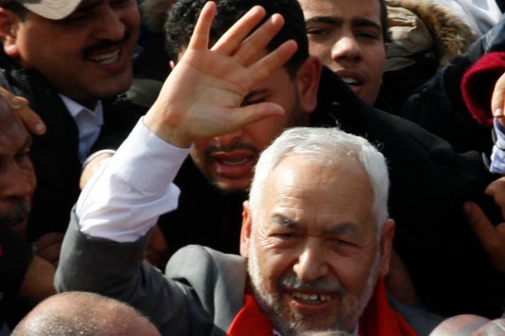 Sheikh Rachid Ghannouchi, head of the Ennahda movement, waves to supporters upon his arrival in Tunis