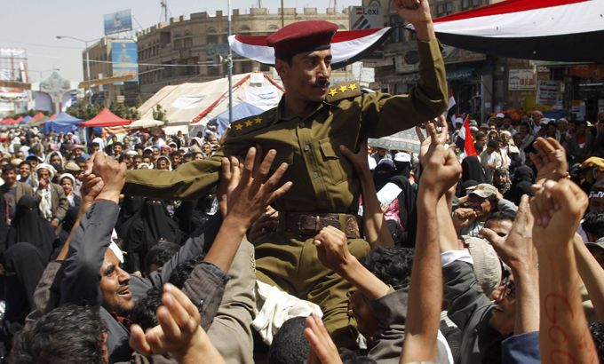 Anti-government protesters carry an army soldier after he joined their protest