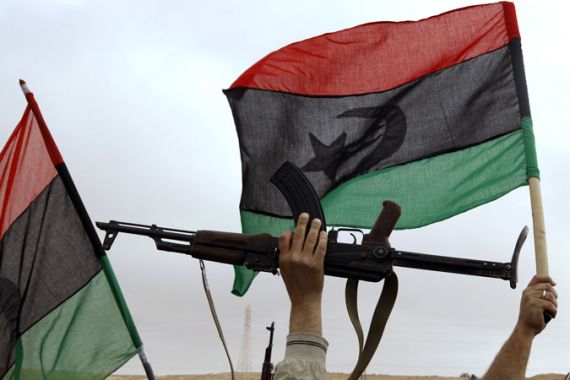 Libya fighter waves weapon