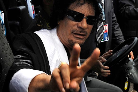 Gaddafi throwing up the peace sign