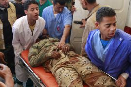 Anti-Gaddafi fighter tended to by medics in Ajdabiya