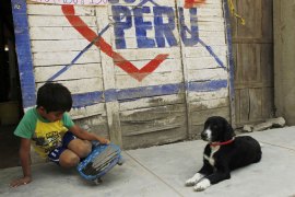 Peru child plays near election sign